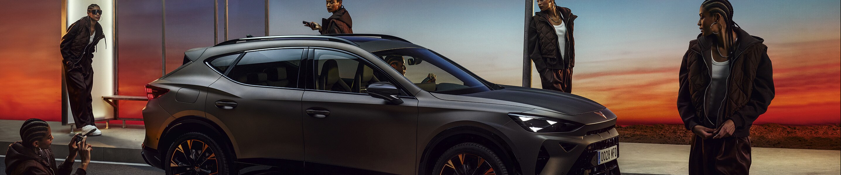 CUPRA Formentor VZ in century bronze matt with sunset in the background and talent.