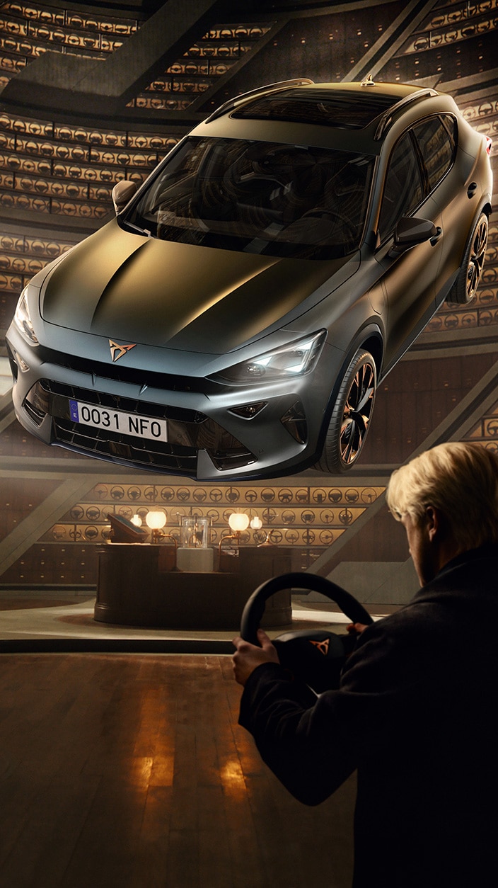 A cinematic wide shot from the CUPRA plug-in hybrid campaign; a driver stands in a vast, circular, wood-panelled archive holding a steering wheel. In the centre, a dark grey CUPRA Formentor levitates dramatically, illuminated by beams of light within the infinite, library-like structure.